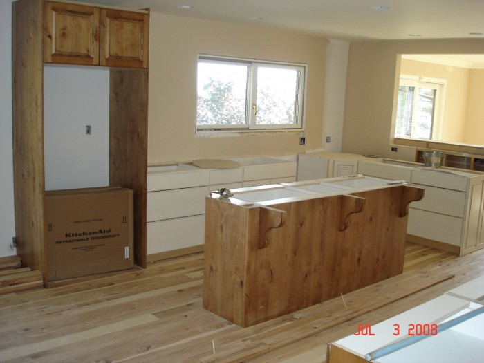 The &quot;Island,&quot; the fridge goes in the &quot;wood&quot; cabinet.  It will have a wooden pannel front.  The gas stove top goes between the K and DR.
