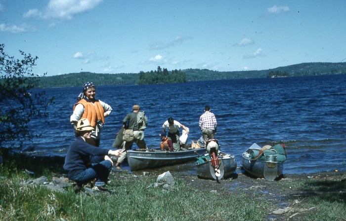 Arlene and Judy waiting for our second load at the end of the portage.  Head scarf was to keep bugs off.  The mossies were huge!