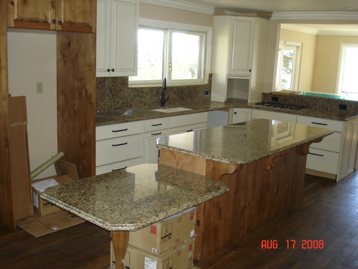 Kitchin sink area, gas stove top between K and DR.