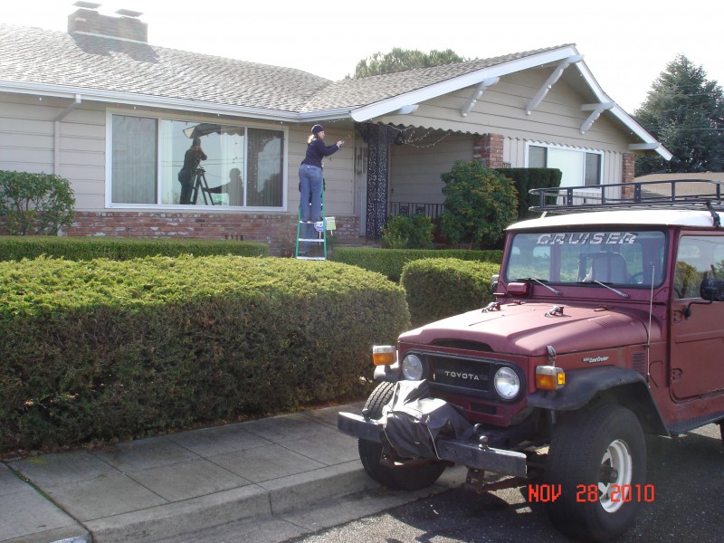 M &amp; H hanging their lights.  Yes, that's Hannah's old Toyota, still going strong!