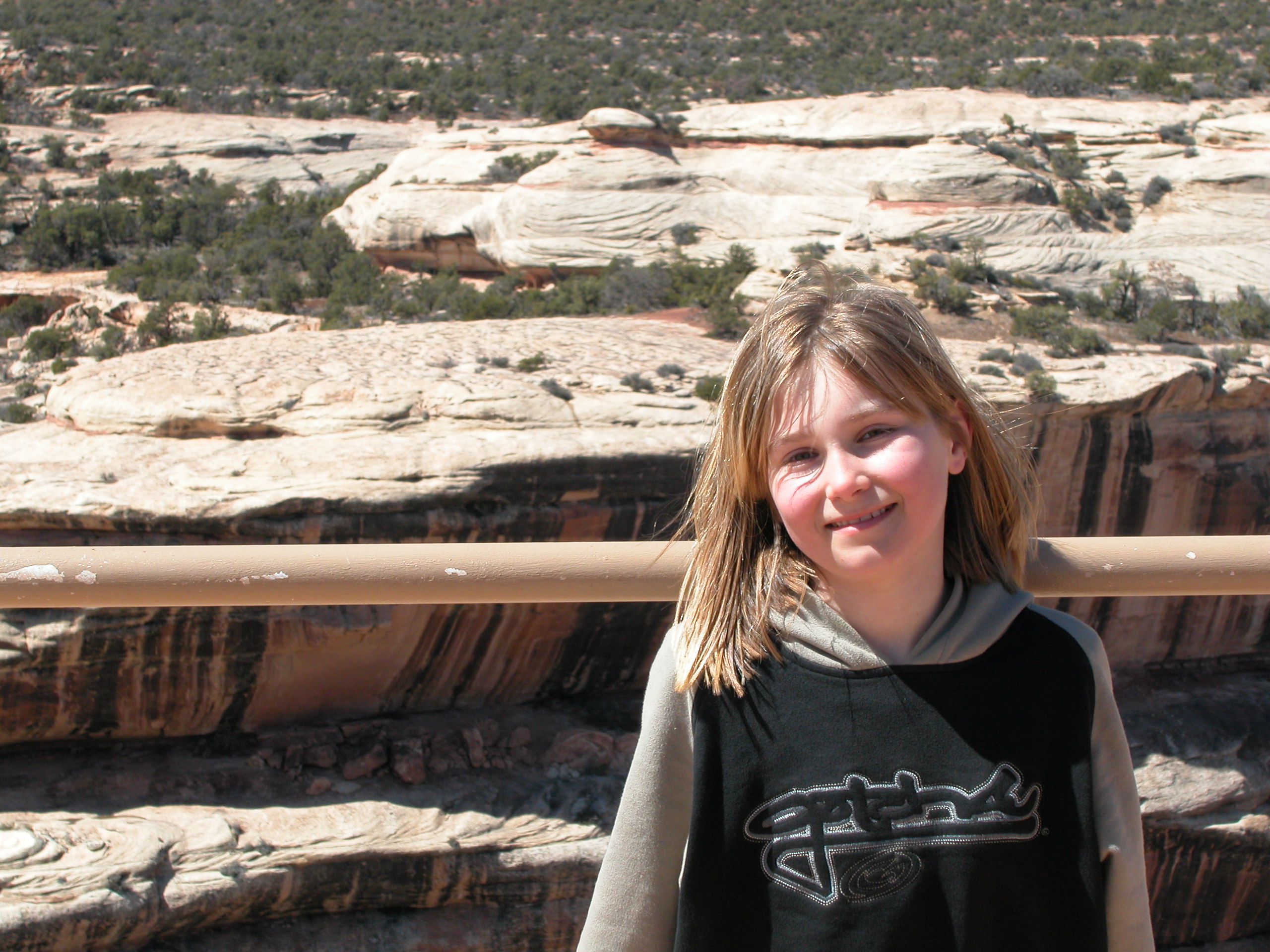 Deirdre at Natural Bridges (check out the little structure under the rock ledge in the background)