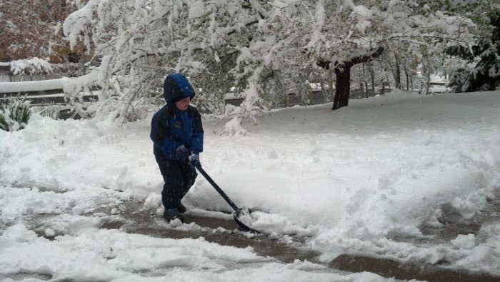 Steven shoveling at his house.