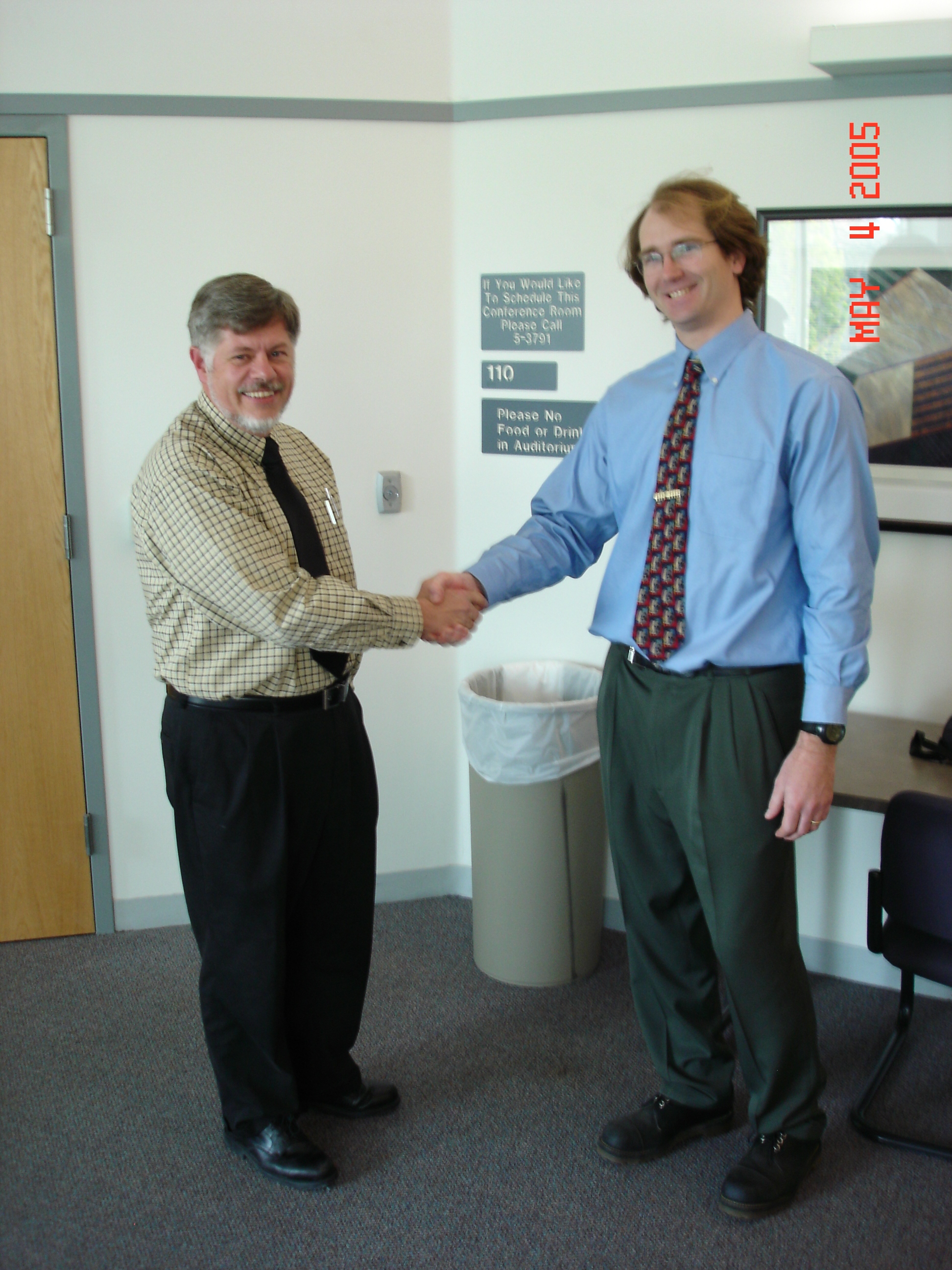 Here he is getting the congratulary hand shake from his prof., Erich Peterson.  Well done, Jason!