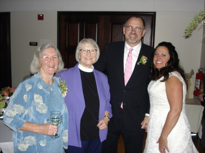 The wedded couple with Mom and our Rector Terri Heyduk at the reception.