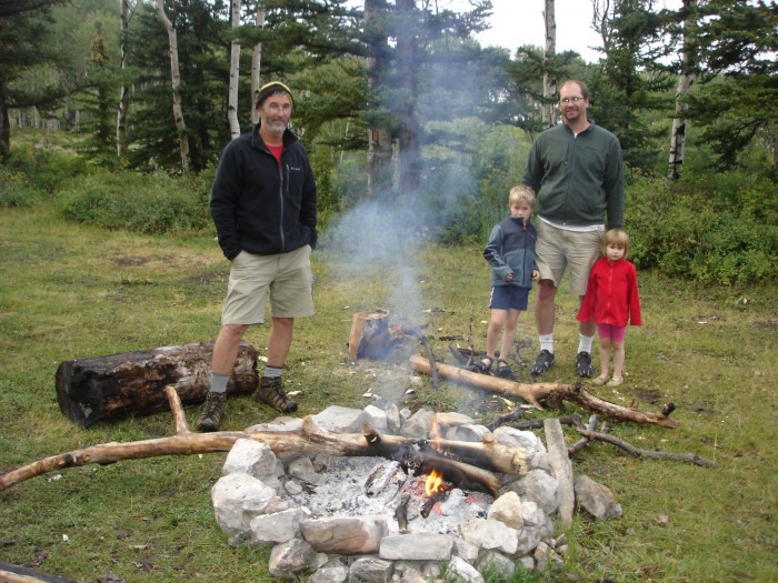 The boys kept the fire going even in the rain.